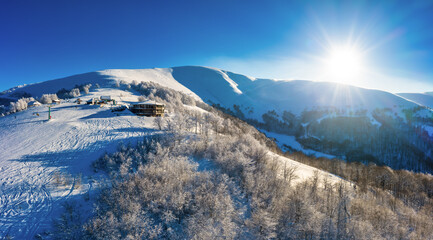 Fototapeta na wymiar Picturesque winter panorama of mountain hills