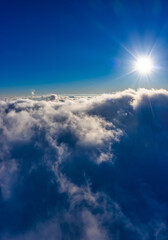 Naklejka na ściany i meble Flight through evening sky with clouds over mountain