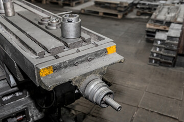 Part of an old milling machine tool and equipment for processing metal structures in the shop of an industrial enterprise