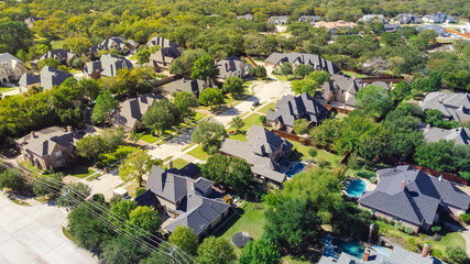 Aerial view upscale neighborhood with expensive houses near service road with power lines in...