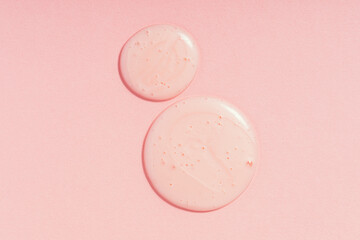 Drops of cosmetic gel on pink background
