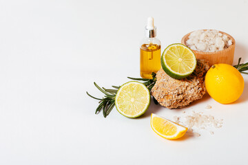 Natural cosmetic oil next to sea salt and fresh citrus
