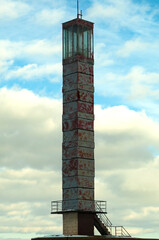 Frozen lake, winter, snow. Old lighthouse on the shore