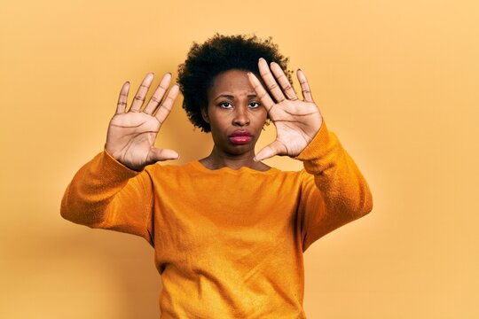 Young african american woman wearing casual clothes doing frame using hands palms and fingers, camera perspective