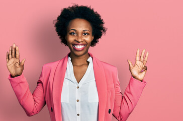 African american woman with afro hair wearing business jacket showing and pointing up with fingers...