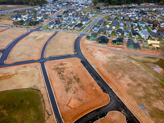 Aerial view of new development and home construction in multiple stages of completion. South...