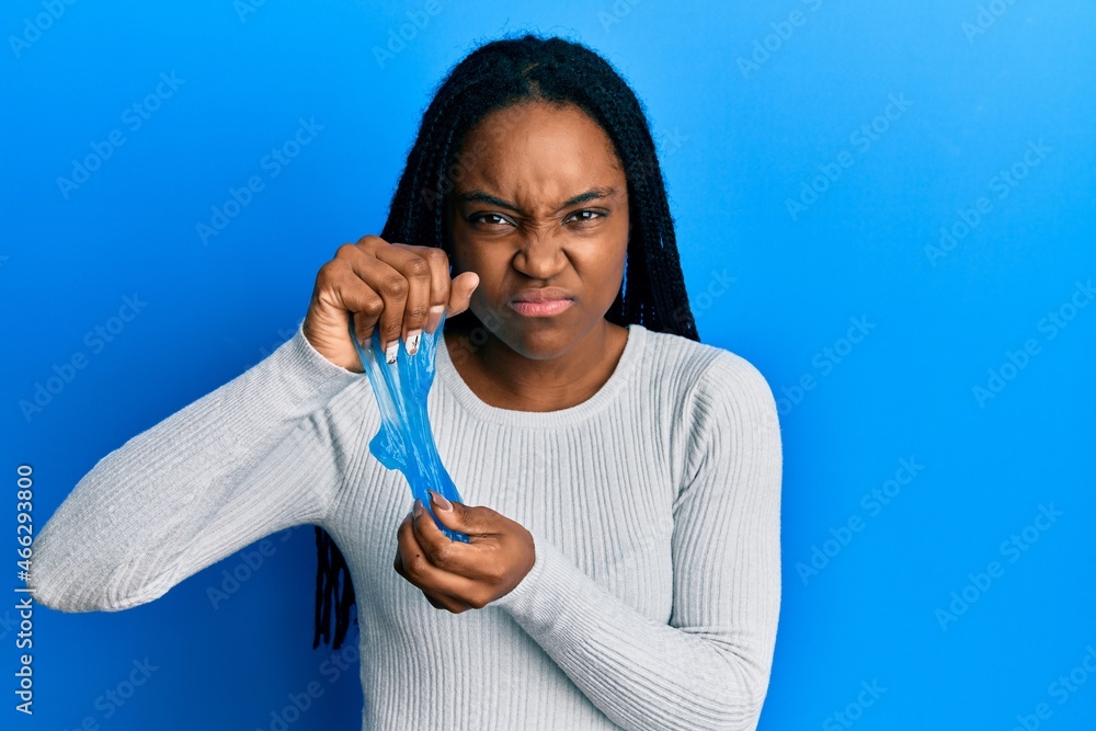 Sticker African american woman with braided hair holding slime skeptic and nervous, frowning upset because of problem. negative person.