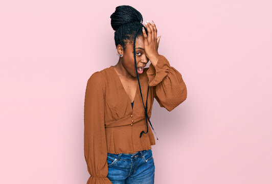 Young african american woman wearing casual clothes surprised with hand on head for mistake, remember error. forgot, bad memory concept.