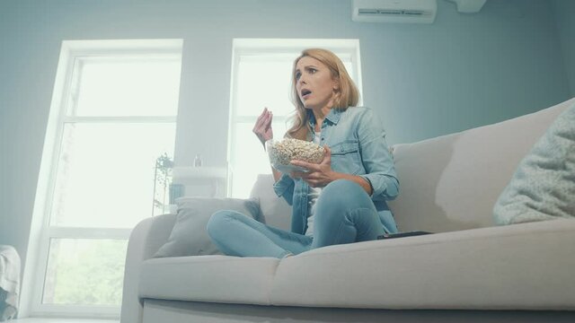 Shocked speechless lady staring tv screen unexpected thrilling moment reaction