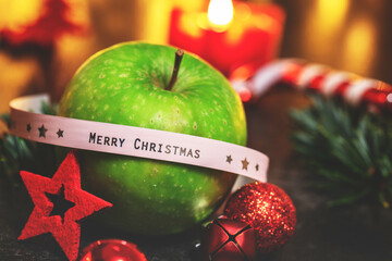 Christmas dekoration Picture with green Apple and red Candle. You can use it for Greeting card or internet Promotion. Merry Cristmas