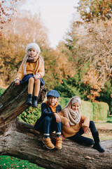 Adorable kids outdoors on autumn day. Brother and two sisters