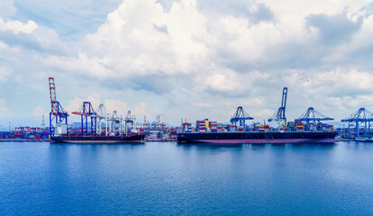 Arial view Cargo ship at seaport waiting for container crane  shipment harbour loading container boxes import and export commercial trade business logistic and transportation of international.