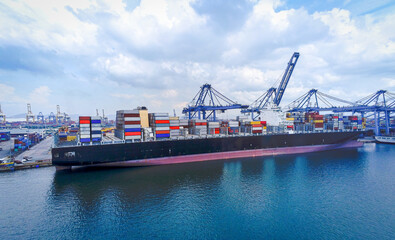 Arial view Cargo ship at seaport waiting for container crane  shipment harbour loading container...