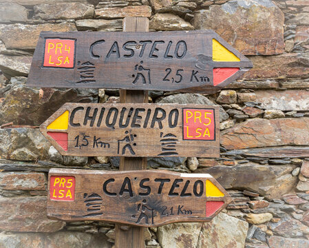 PR4 and PR5 LSA (Lousa) walking trails - wooden signpost pointing the way and distances to Chiqueiro Schist Village and the Castle, Lousa, Portugal