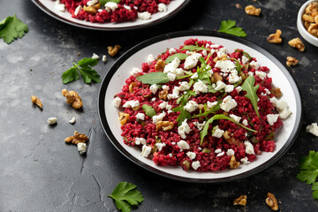 Bulgur salad with beetroot, walnuts, arugula and feta cheese. Healthy diet food