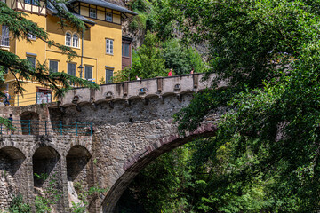 View of the famous Steinerner Steg - Ponte Romano bridge, a two-arched, stone-built footbridge across the Passer in Merano, South Tyrol, northern Italy.