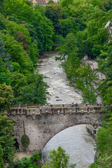 View of the famous Steinerner Steg - Ponte Romano bridge, a two-arched, stone-built footbridge across the Passer in Merano, South Tyrol, northern Italy.