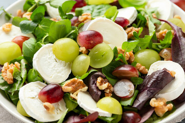 Italian salad with goat cheese, grapes and walnuts. Healthy Food