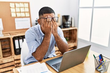 Young arab man stressed working at office