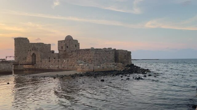 The city of Sidon in Lebanon. Sidon Sea Castle, built by the crusaders - Saida corniche and building. Sidon sea at sunset