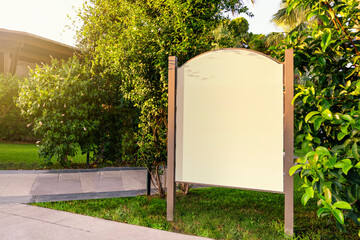 an empty billboard mockup outside the city or in a green park or in a hotel, advertising a spa or vacation in a hotel outside the city