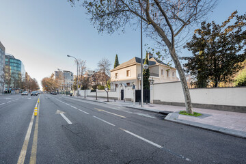 Avenue in the city of Madrid with beautiful single-family homes and office buildings with glass facades