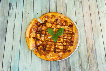 Wheat flour pizza with meat and barbecue sauce viewed from the top