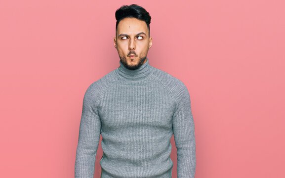 Young arab man wearing casual clothes making fish face with lips, crazy and comical gesture. funny expression.