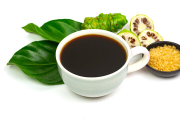 Noni juice in ceramic cup and fresh noni fruit with green leaf isolated on white background.