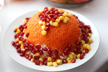 Bright juicy salad with pomegranate seeds and corn on a white plate