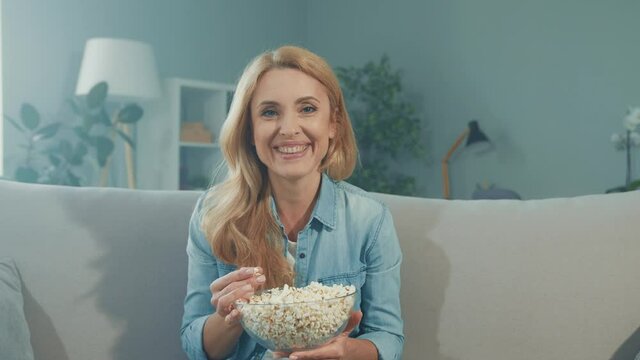 Funny positive lady watch tv comedy sitcom enjoy popcorn snack