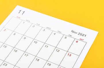 November 2021 calendar sheet on yellow background.