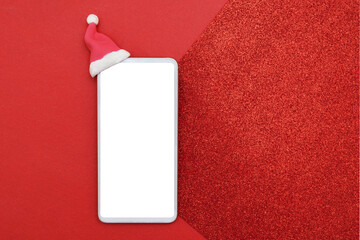 Mock up smartphone in santa hat on red glitter background