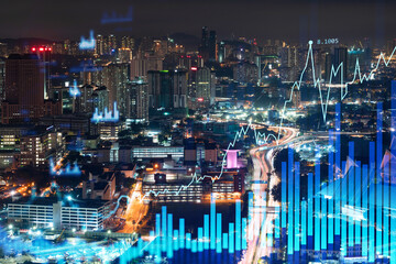 Fototapeta na wymiar Stock market graph hologram, night panorama city view of Kuala Lumpur. KL is popular location to gain financial education in Malaysia, Asia. The concept of international research. Double exposure.