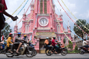 Motorcycles and Pink Catholic Church in Saigon,...