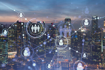 Glowing Social media icons on night panoramic city view of Singapore, Asia. The concept of networking and establishing new connections between people in businesses. Double exposure.