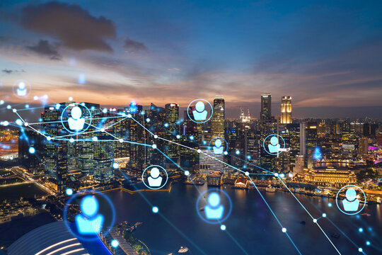 Glowing Social media icons on night panoramic city view of Singapore, Asia. The concept of networking and establishing new connections between people in businesses. Double exposure.