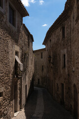 narrow alley in the town of pals on the touristic Costa Brava of Girona on a sunny summer day
