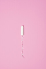 hygienic feminine tampon for menstruation on pink background