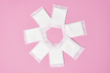 packaged cotton sanitary pad napkin on pink background