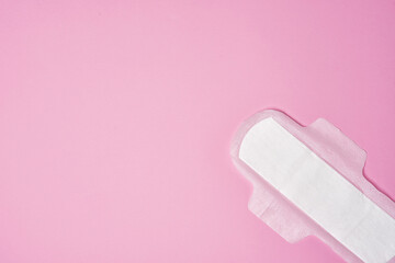 cotton sanitary pad napkin on pink background, copy space
