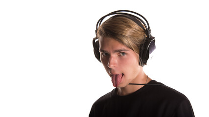 A young attractive guy with beautiful eyes listens to music on headphones.