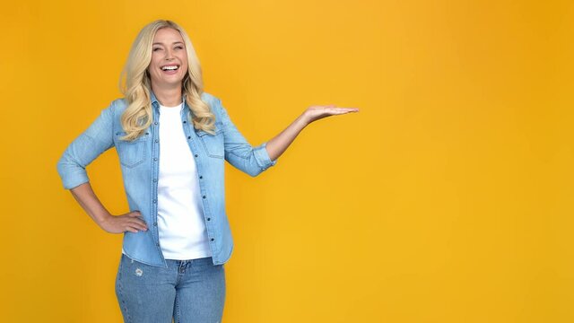 Reliable cheerful nice adviser lady presenting empty space invisible object