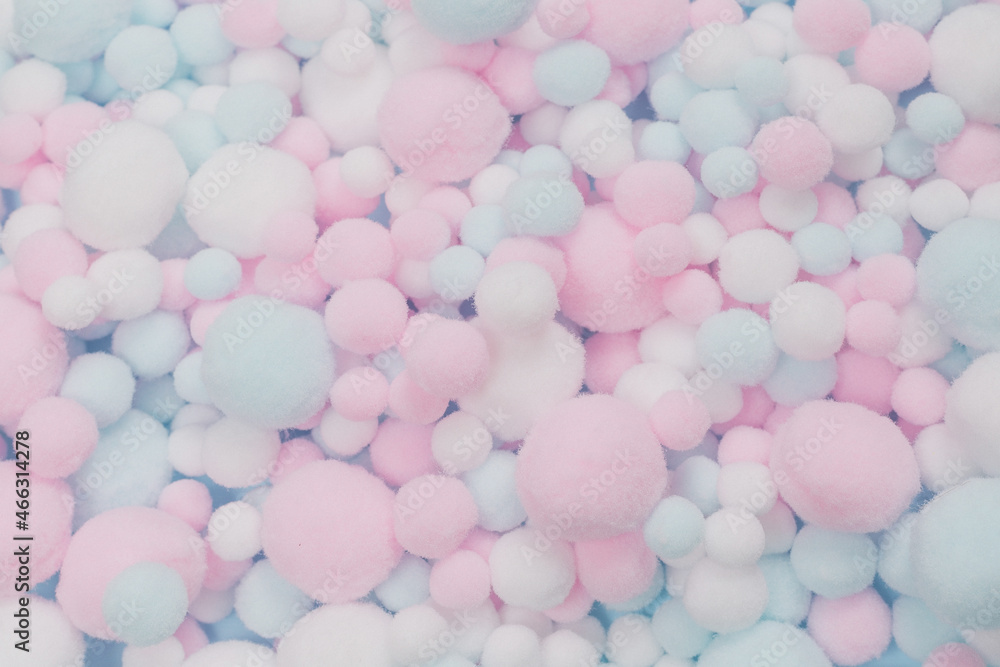 Sticker white, pink and blue soft pompons as a background.