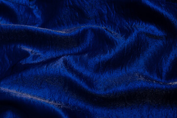 Purple shiny fabric as background. Top view.