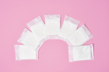 packaged cotton sanitary pad napkin on pink background