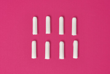 hygienic feminine tampons for menstruation on a pink fuchsia background