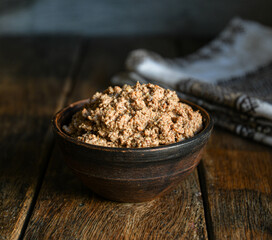 Chicken pate in a ceramic bowl on a wooden table. Home cooking in the village.