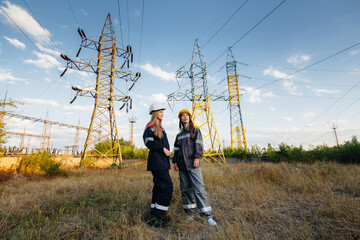 Women's collective of energy workers conducts an inspection of equipment and power lines. Energy
