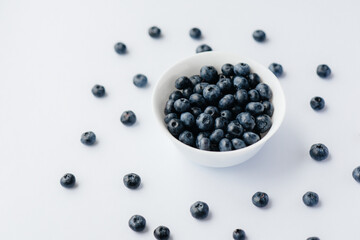 Beautiful ripe blueberries in a glass bowl on a white background. Healthy food, and vitamins.